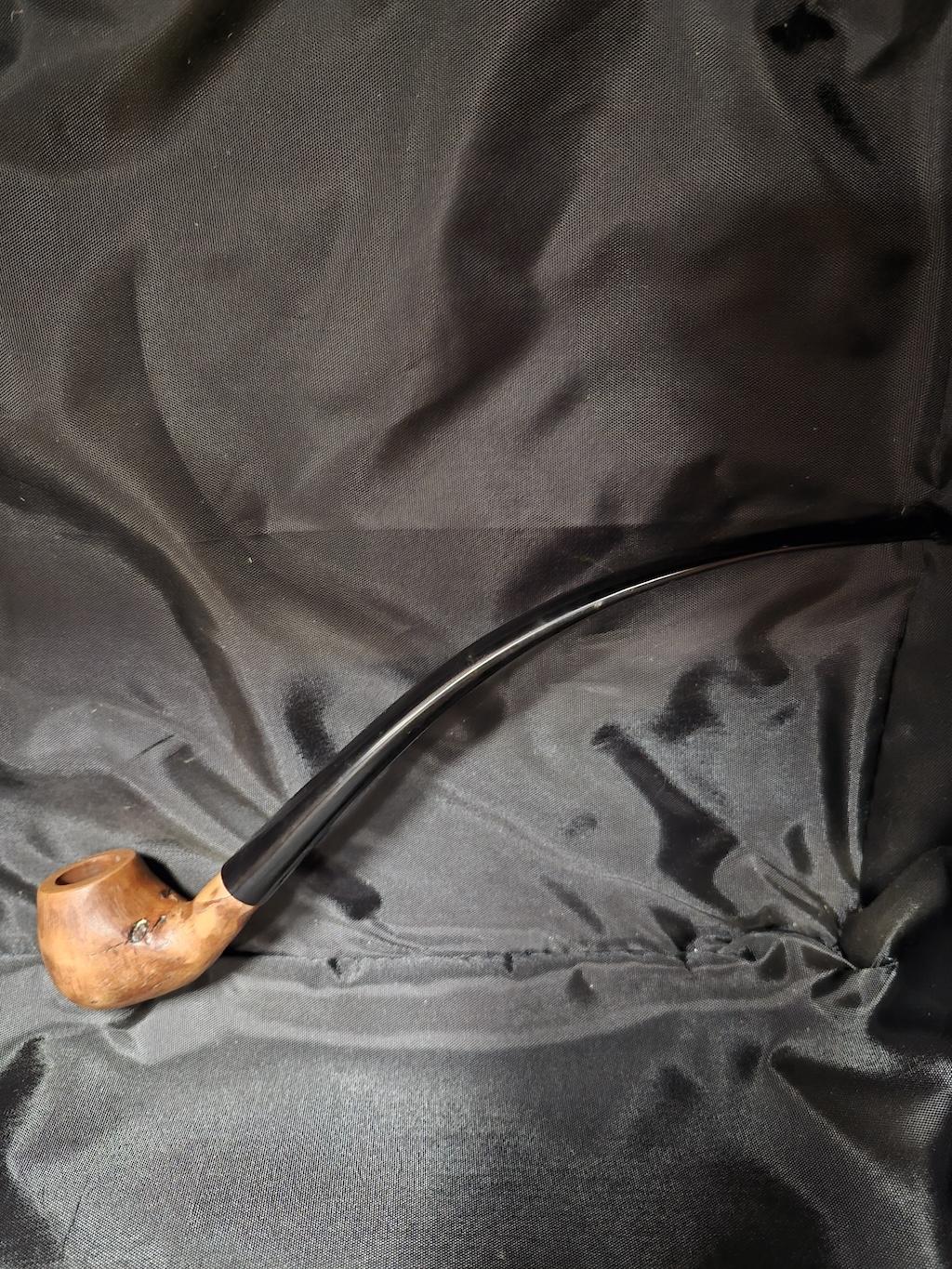 Tobacco pipe rack photograph with 3 custom made artisan crafted tobacco pipes different styles resting in hand carved pipe rack