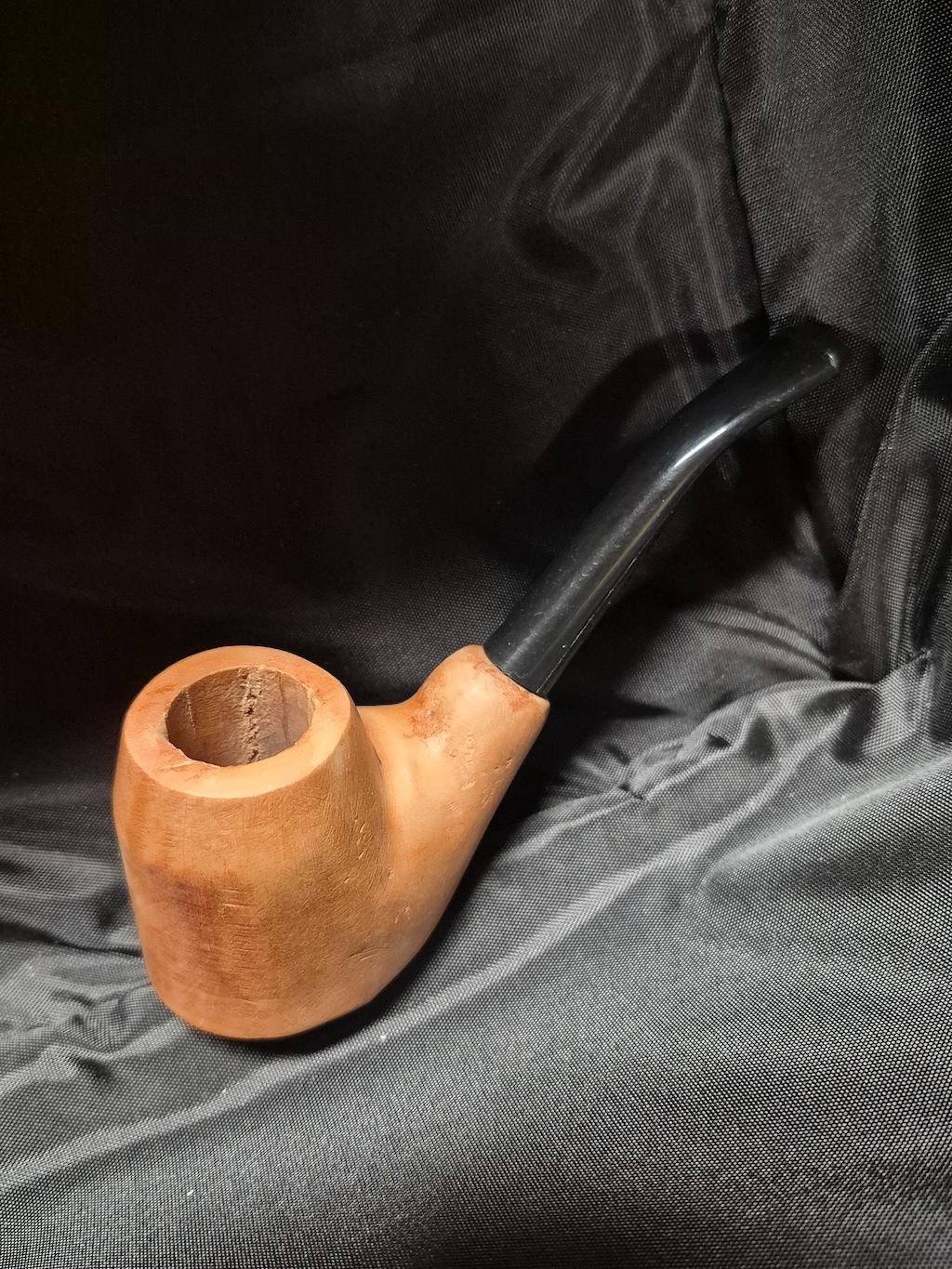 Tobacco pipe rack photograph with 3 custom made artisan crafted tobacco pipes different styles resting in hand carved pipe rack