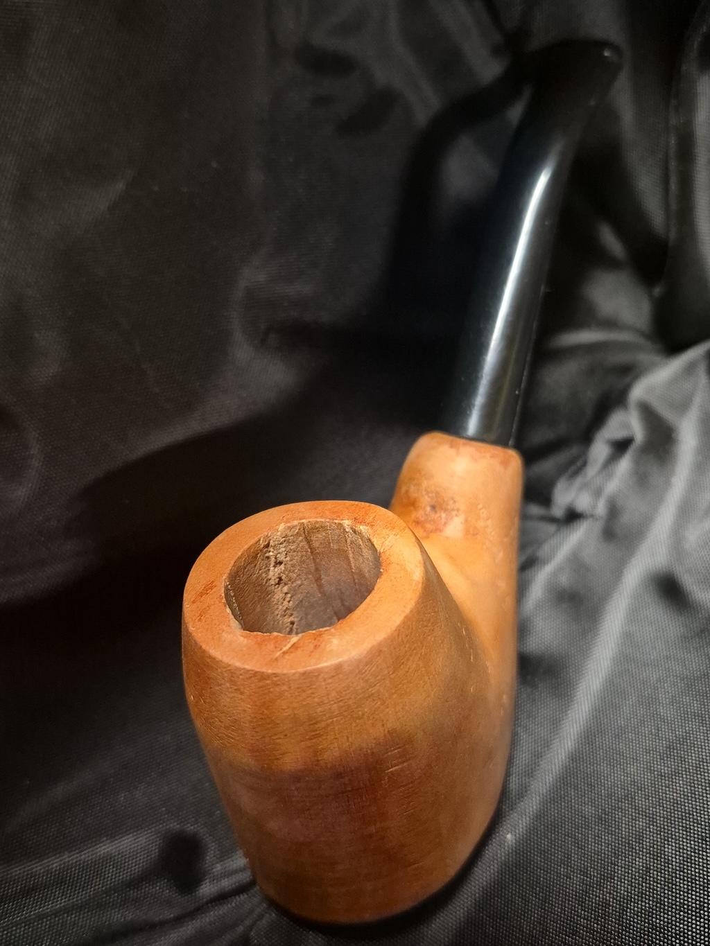 Tobacco pipe rack photograph with 3 custom made artisan crafted tobacco pipes different styles resting in hand carved pipe rack