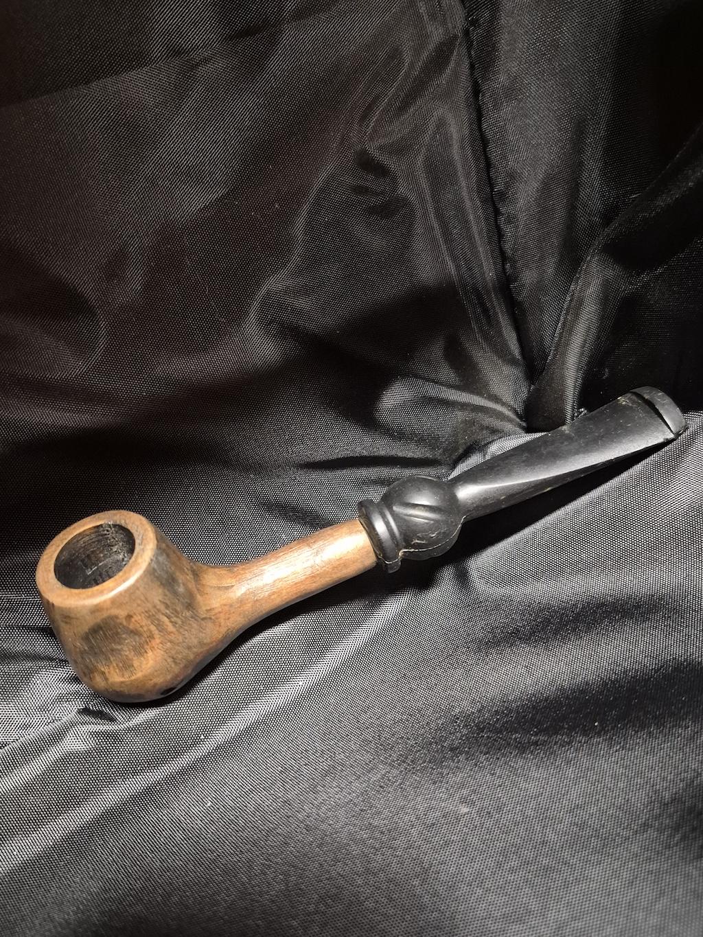 Tobacco pipe rack photograph with 3 custom made artisan crafted tobacco pipes different styles resting in hand carved pipe rack
