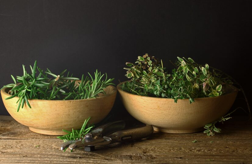 Wooden bowls of fresh cut herbs from the garden to be clipped and bundled